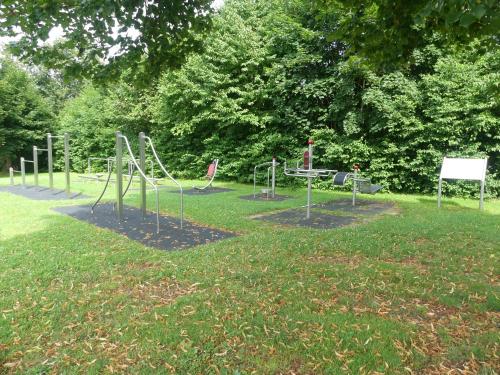 a park with a playground with a slide in the grass at Dreiländereck mit Sauna und Pool, Wohnung 403 in Hauzenberg