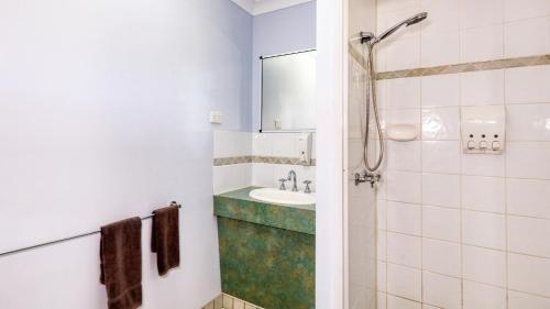 a bathroom with a sink and a shower at Koorawatha Homestead Motel in Bororen