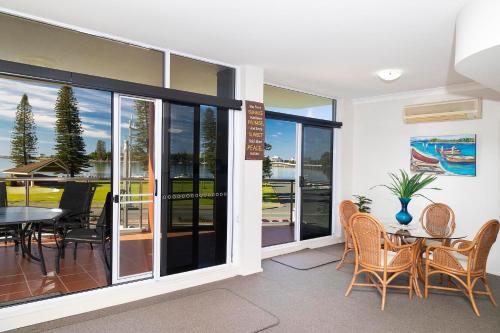 a dining room with a table and chairs at Sunrise 102 in Tuncurry