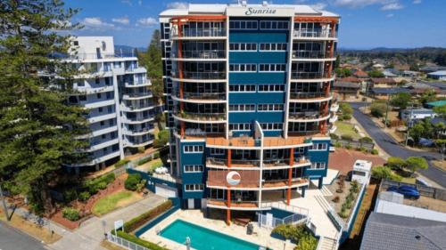an aerial view of a building with a pool at Sunrise 102 in Tuncurry