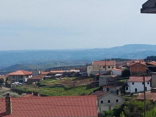 a village with houses and mountains in the background at Casa Macedo in Alfândega da Fé
