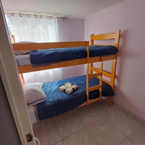 a room with two bunk beds and a chair at depa playa in Arica