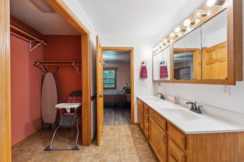 a bathroom with a sink and a mirror at Dog-friendly 6-acre 5BR 3BA home, game room, deck, Wisconsin Dells 10min in Lyndon Station