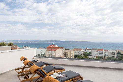 a balcony with a view of the ocean at Villa AG in Podstrana