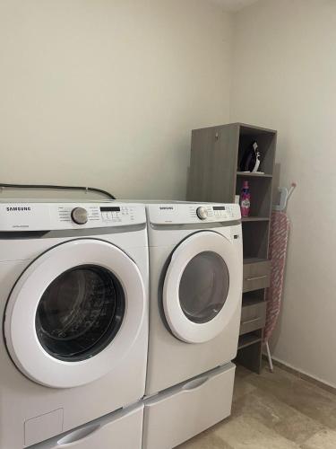 two washing machines sitting next to each other in a room at Comodidad y confort en casa Arennas in Mérida