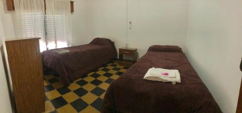 a small bedroom with a bed and a couch at La Magdalena in Chajarí