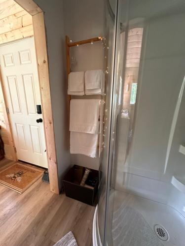 a bathroom with a shower with towels in it at Bluestone Acres Farm in Vavenby