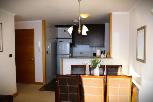 a kitchen with black cabinets and a counter top at HOM I Edificio Valle Blanco Valle Nevado 2D2B SKI IN&OUT in Farellones