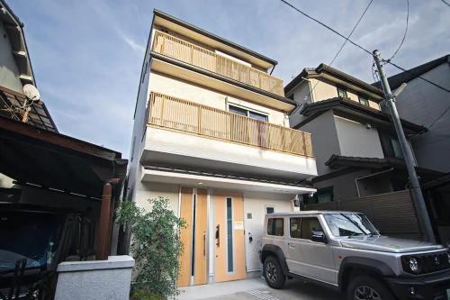 a white truck parked in front of a house at 二条 秋 designer house 新築 2LDK 1階庭付き 4人宿泊可能 in Kyoto