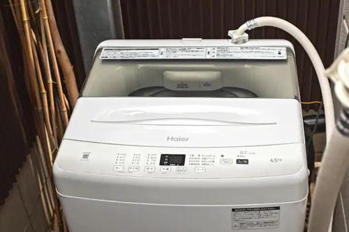 a printer with a cord sticking out of it at 二条 秋 designer house 新築 2LDK 1階庭付き 4人宿泊可能 in Kyoto