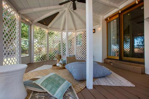 a porch with an umbrella on a wooden deck at Oasis Retreat - Hot Tub - King Bd - Fire Pit - Games - Near Golf - 4 Bdrm - Sleeps up to 12 in Albuquerque