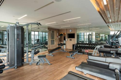 a gym with treadmills and exercise equipment in a building at Staybridge Suites Bangkok Thonglor by IHG in Bangkok
