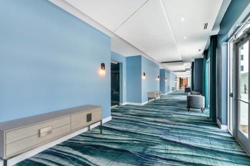an empty hallway in a hospital with blue walls at EVEN Hotel Waco - University Area by IHG in Waco