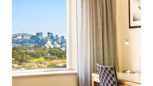 a window with a view of the sydney skyline at Holiday Inn Sydney Potts Point in Sydney