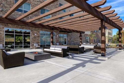 a patio with furniture and a wooden pergola at Holiday Inn Express & Suites Ontario - Chino Hills by IHG in Chino Hills