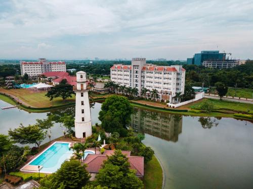 a building with a clock tower next to a body of water at Sotogrande Iloilo Hotel in Iloilo City