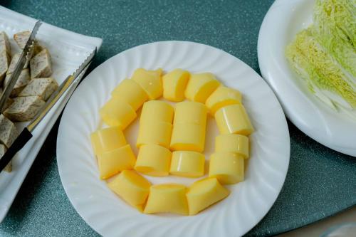 a plate of cheese on a table with bread at Le President Hotel in Phnom Penh