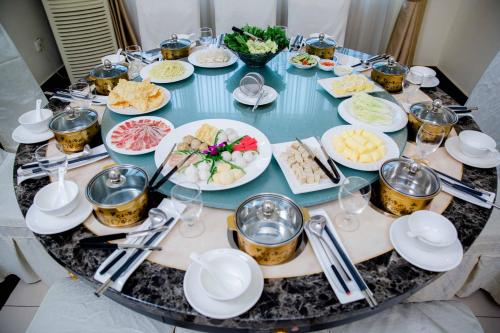 a table with plates of food on top of it at Le President Hotel in Phnom Penh
