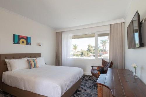 a bedroom with a large bed and a window at Best Western Adelaide Airport in Adelaide