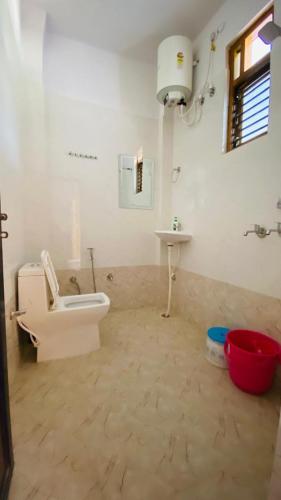 a bathroom with a toilet and a sink at Green View Luxury Apartments in Varanasi