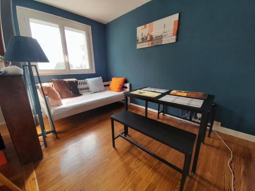 a living room with a couch and a window at Blue escape in Saint-Brieuc