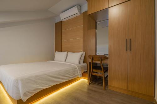 a small bedroom with a bed and a desk at Casa Residence Bali By Bali Cabin in Kerobokan