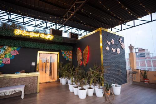 a restaurant with a bunch of potted plants in front of it at Hotel Radiance Courtyard in Varanasi
