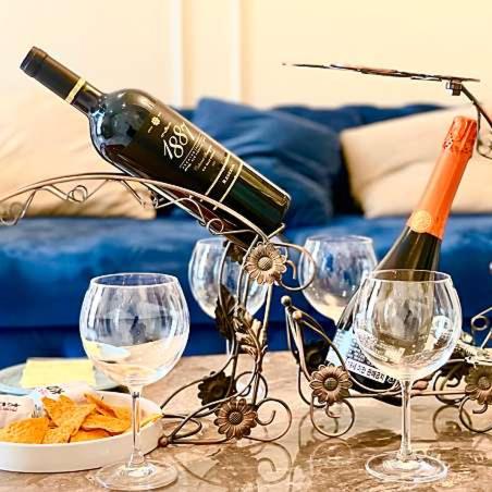 a bottle of wine and wine glasses on a table at Calton Hill Hotel in Jeonju