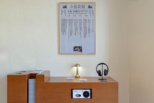 a desk with a light and a calendar on the wall at Surim Hotel Sokcho by AanK in Sokcho