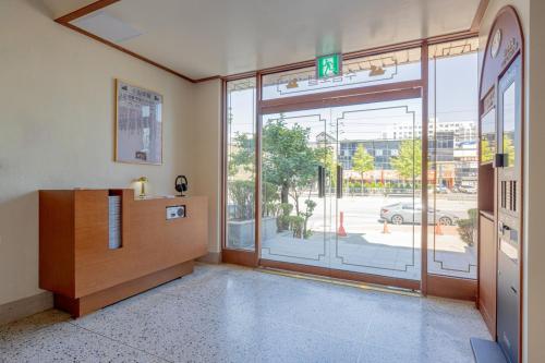 a lobby with a large glass door with a view of a street at Surim Hotel Sokcho by AanK in Sokcho