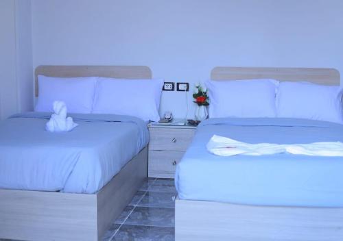two beds sitting next to each other in a bedroom at City Stars Hotel in Cairo