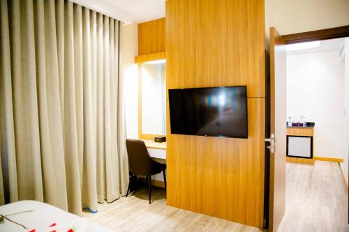 a hotel room with a television on a wooden door at Le President Hotel in Phnom Penh