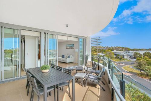 a patio with a table and chairs on a balcony at Beachside Paradise at Cotton Beach 44 in Casuarina