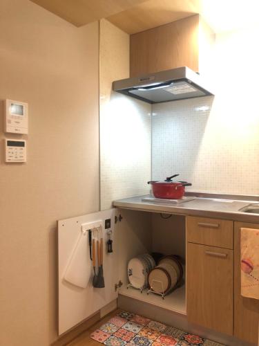 a kitchen with a sink and a counter top at 静雅の宿 in Kyoto