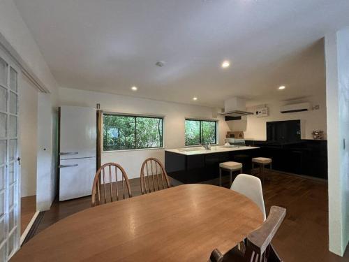 a kitchen and dining room with a wooden table and chairs at sorairo in Kumanoshō