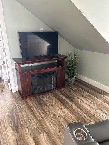 a living room with a tv and a fireplace at Sea Shell in Old Orchard Beach