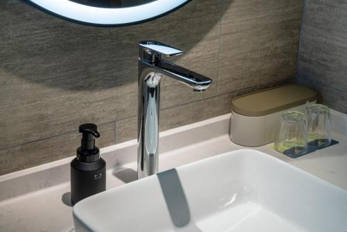 a bathroom sink with a faucet on a counter at Atour Hotel Changsha Binjiang Financial Center in Changsha