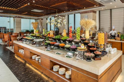 a buffet line with many different types of food at Mandila Beach Hotel Danang in Da Nang