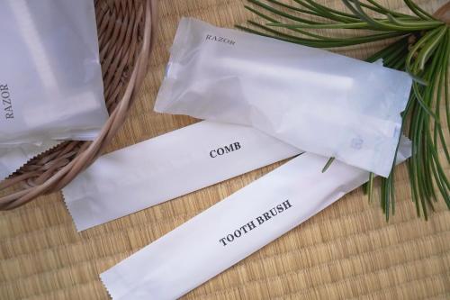 two white paper bags sitting next to a basket at Japanese House Osaka Sennan Hotel 大阪泉南酒店和築 in Tannowa