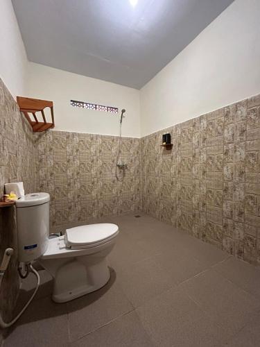 a bathroom with a toilet and a shower at Buntera Homestay Sidemen in Sidemen