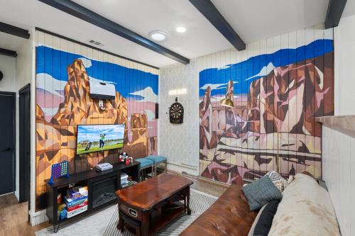 a living room with a couch and a tv at Walk to GC Train Depot and Route 66, king beds, game room, BBQ, firepit in Williams