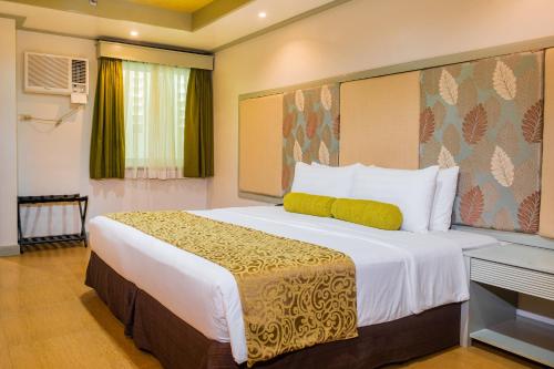 a bedroom with a large bed in a room at La Piazza Hotel and Convention Center Inc. in Legazpi