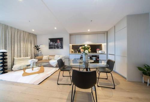 a living room with a table and a couch at Modern Urban Oasis in the Heart of Chinatown in Sydney