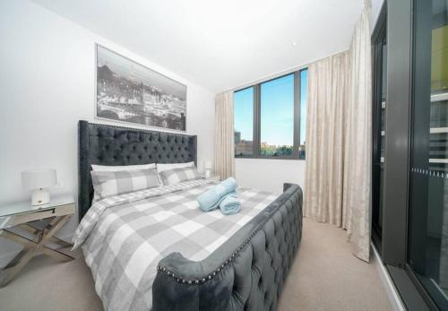 a bedroom with a large bed and a window at Modern Urban Oasis in the Heart of Chinatown in Sydney