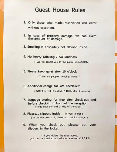 a document with a guest house rules at Seoul Cube Myeongdong in Seoul