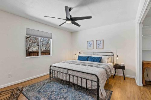 a bedroom with a bed and a ceiling fan at Walk to GC Train Depot and Route 66, king beds, game room, BBQ, firepit in Williams