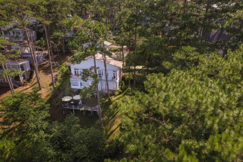 an aerial view of a white house in a forest at The Dream Villa Best Lake View in Xuan An