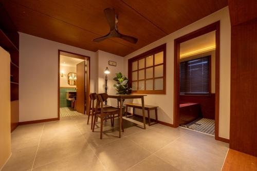 a dining room with a table and chairs and a ceiling at Surim Hotel Sokcho by AanK in Sokcho