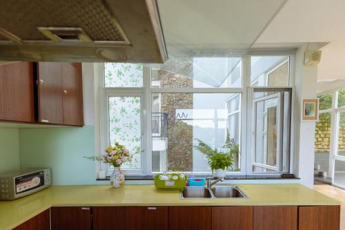 a kitchen with a sink and a large window at The Dream Villa Best Lake View in Xuan An