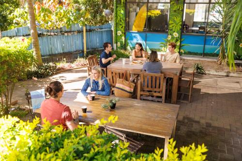 a group of people sitting at a table at YHA Coolangatta Gold Coast in Gold Coast